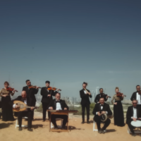 Firqat Alnoor, the Arabic classical music orchestra composed of Jewish and Arab musicians, filming an Umm Kulthum song on the dunes of Dubai, released on November 23, 2025 (Courtesy)